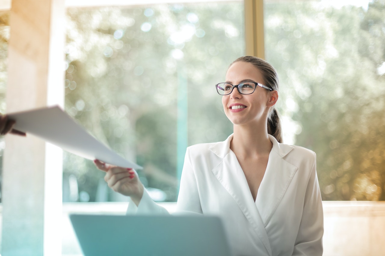 Woman handing over rental agreement paperwork