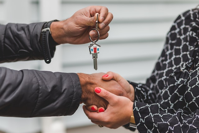 A person receiving the keys to a house from another person