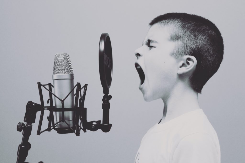 A kid shouting into a microphone