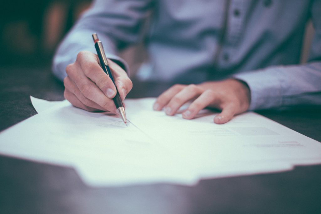 A person signing a rental agreement